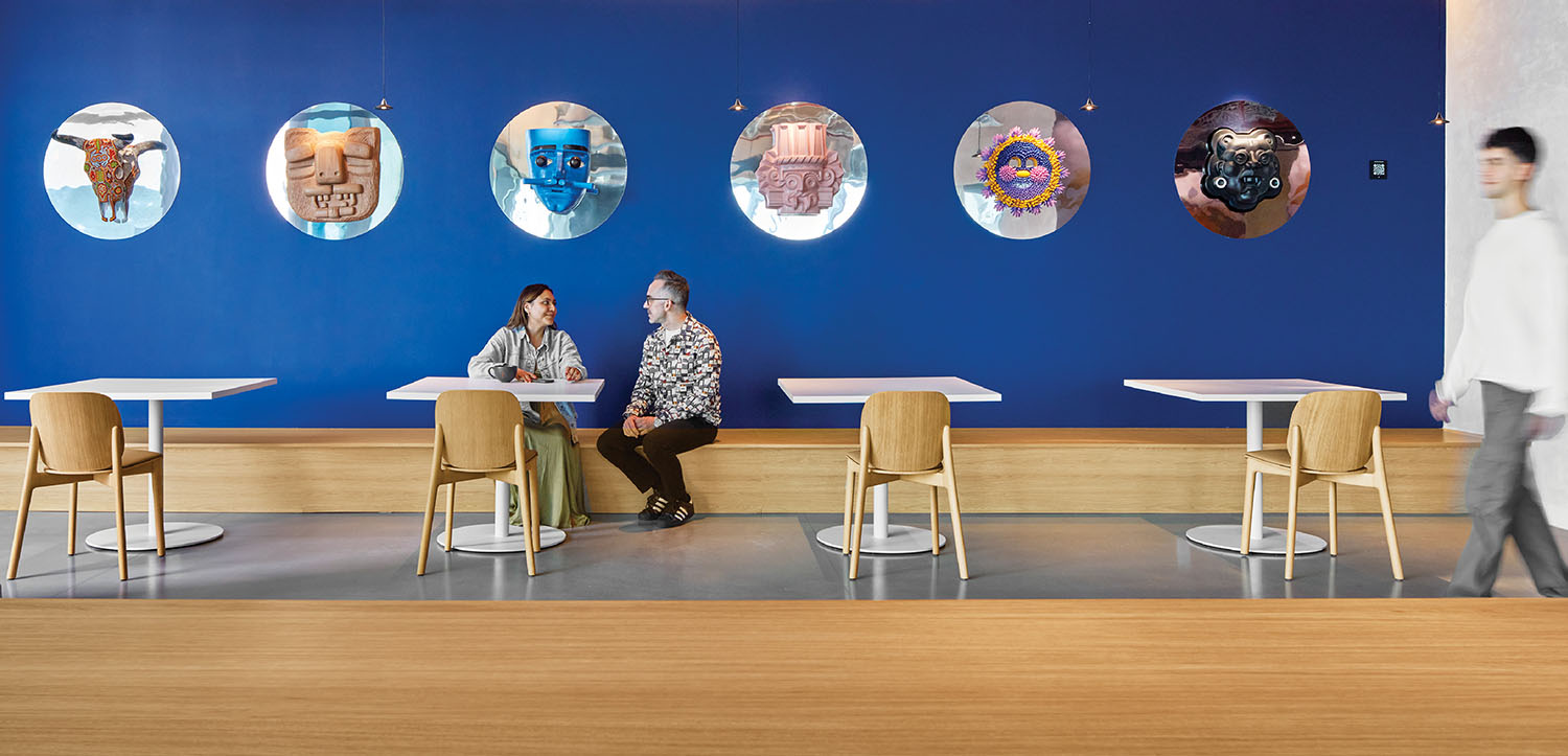 A woman sitting at a table in a blue room