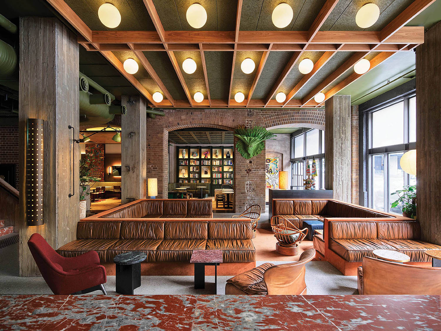 A large room with a couch and a bar.