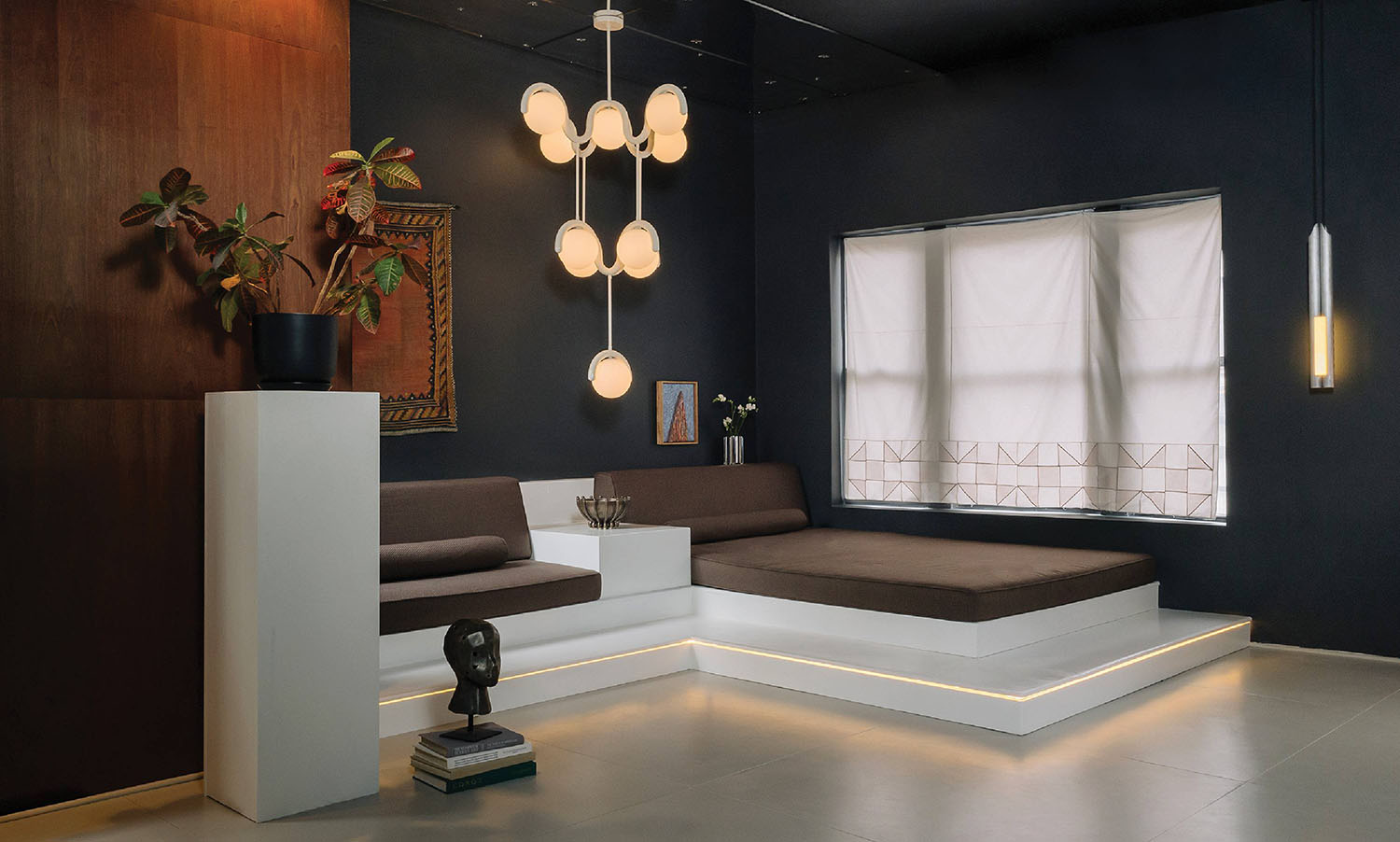 A living room with a couch and a lamp.