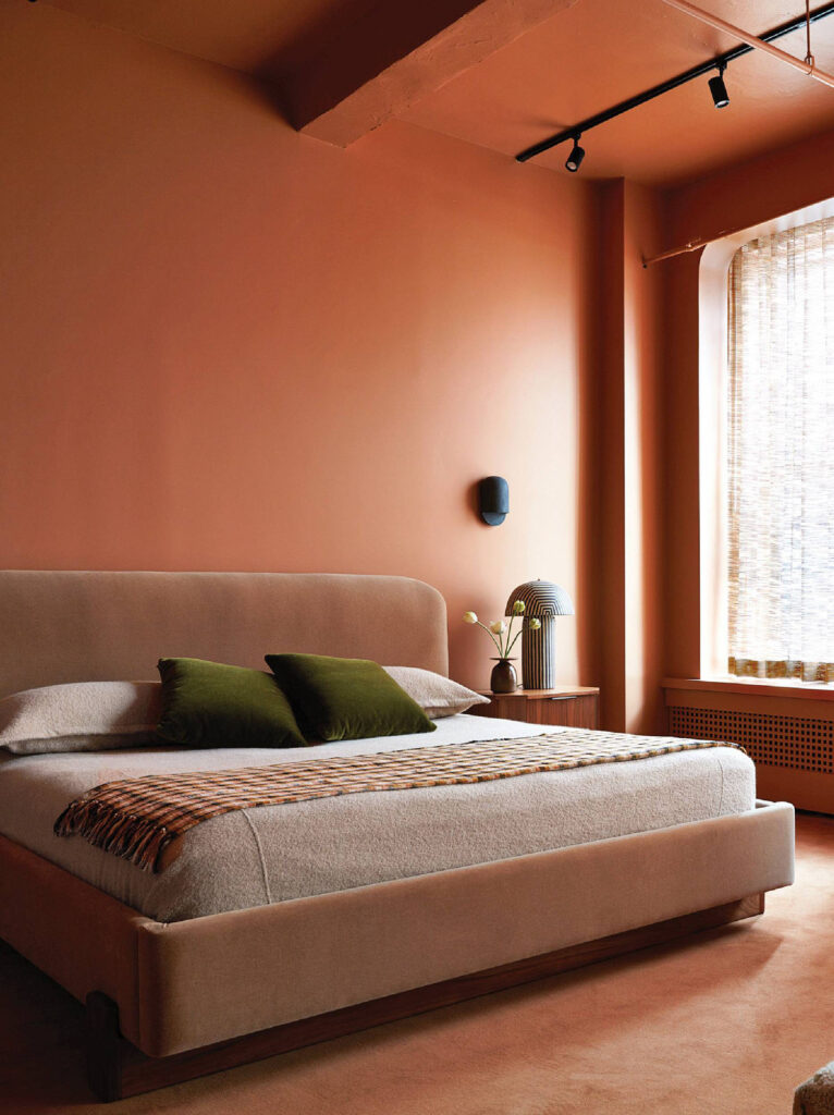 A bedroom with a bed and a window.