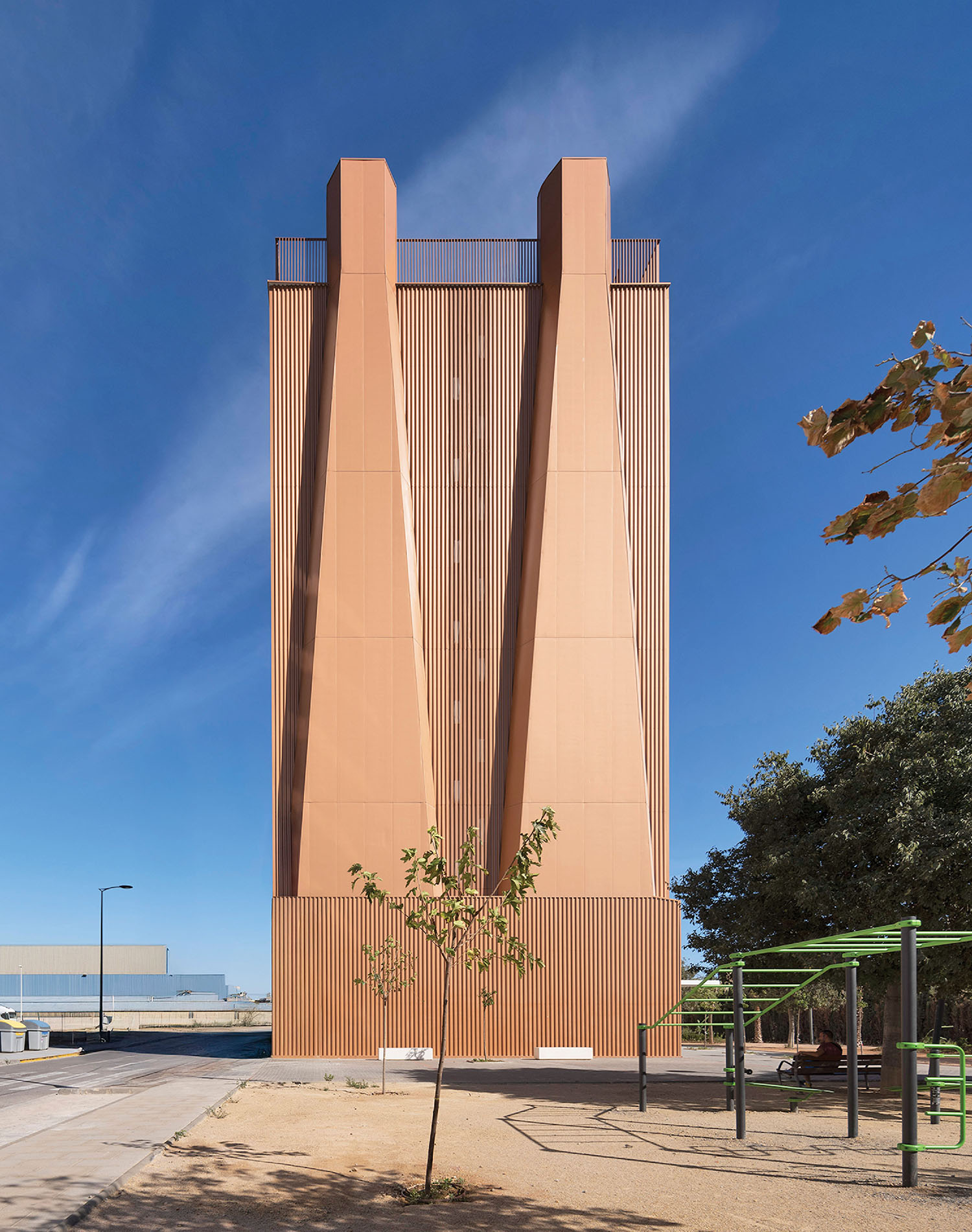 a tall building with a long, copper facade