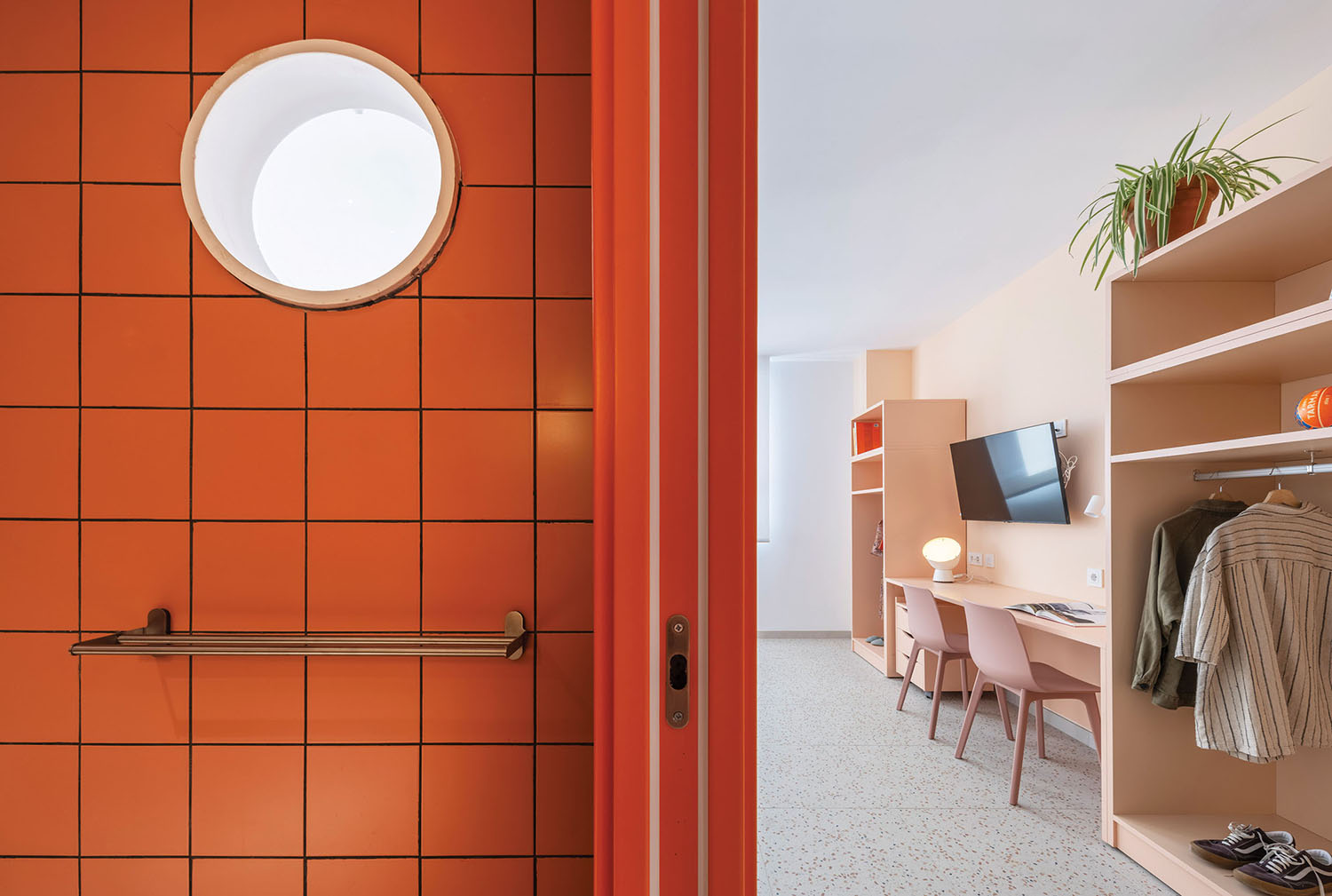 a room with a red door and a white window