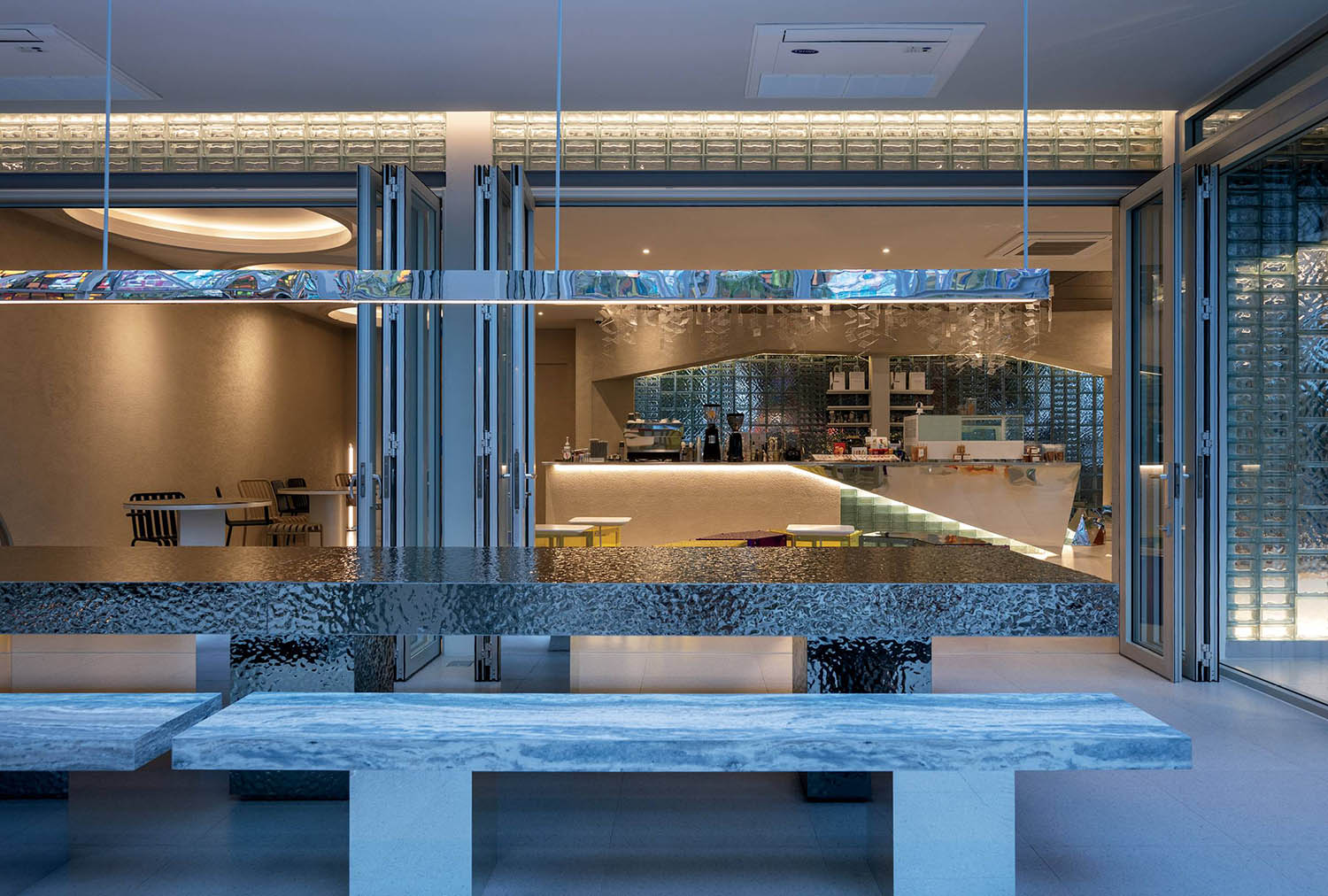 A modern kitchen with a large table and a bench.