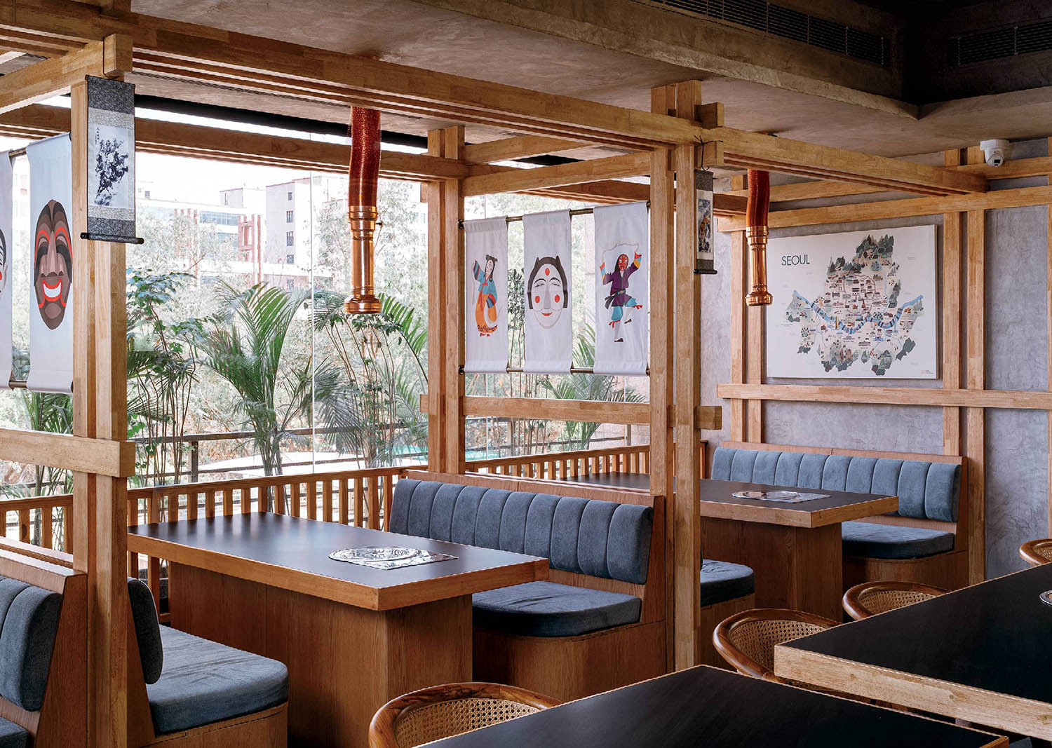 A restaurant with wooden tables and chairs.