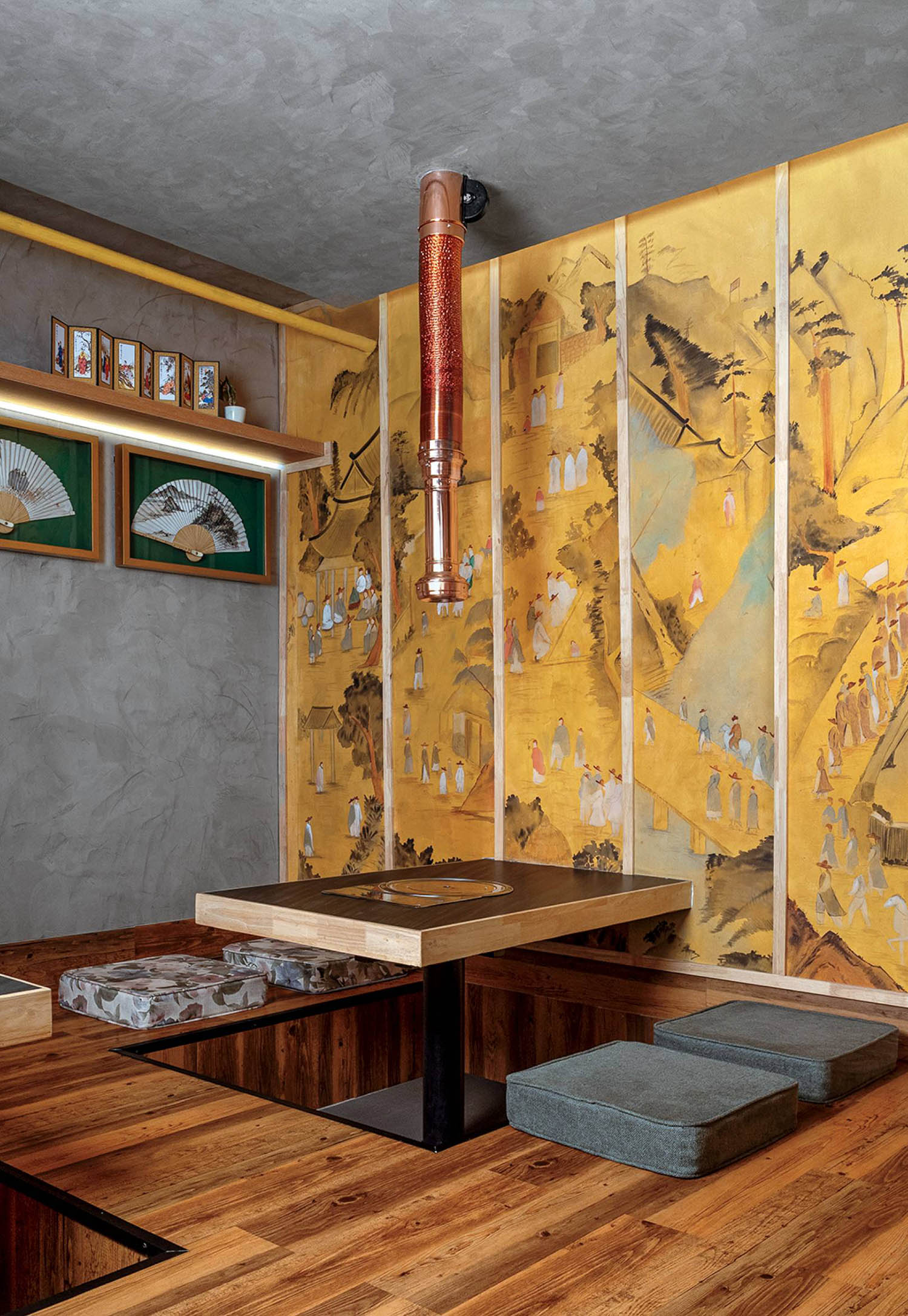 A room with a wooden table and a painting on the wall.