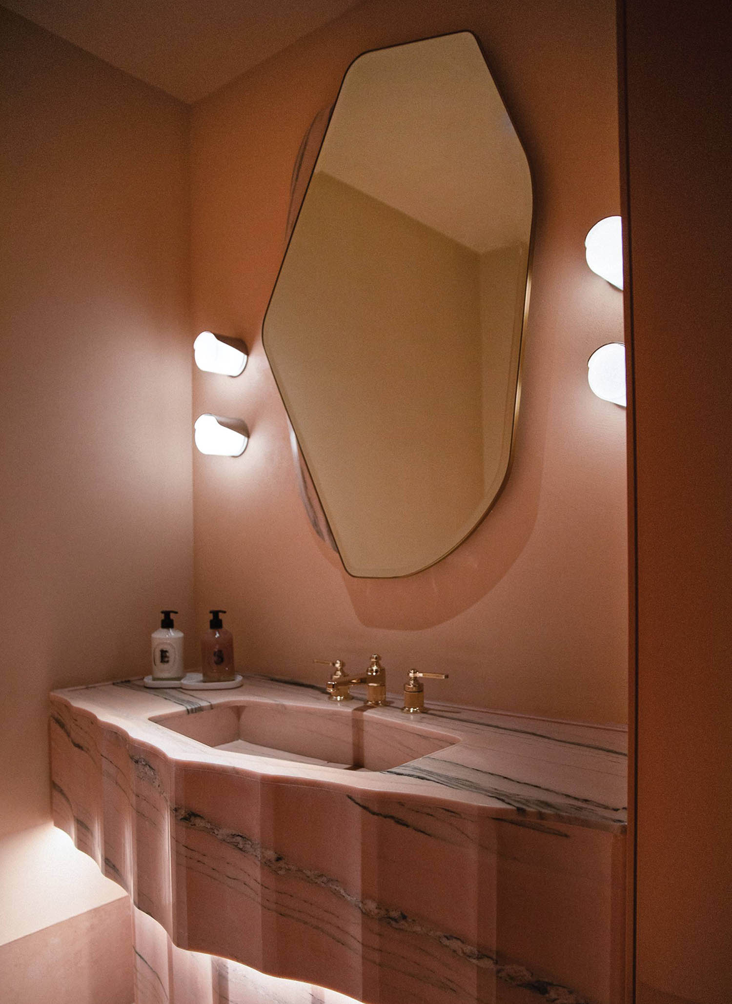 A bathroom with a sink and a mirror.