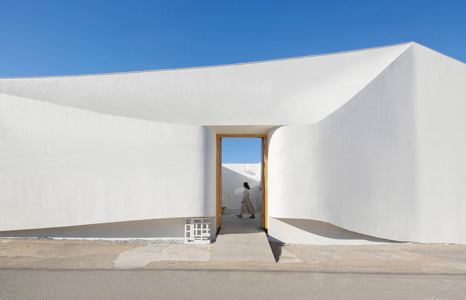 A white building with a large doorway.