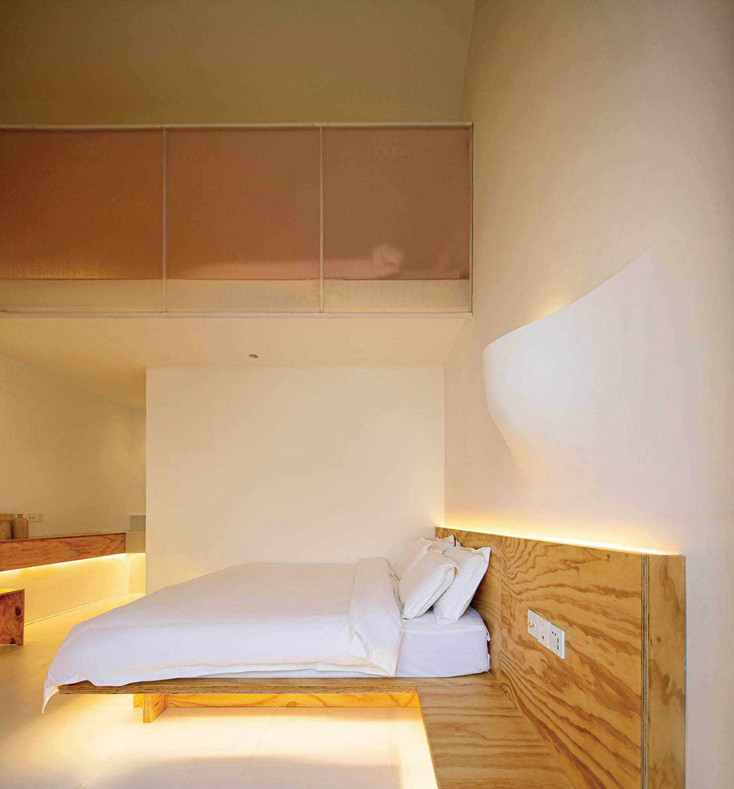 A bed in a room with a wooden headboard.