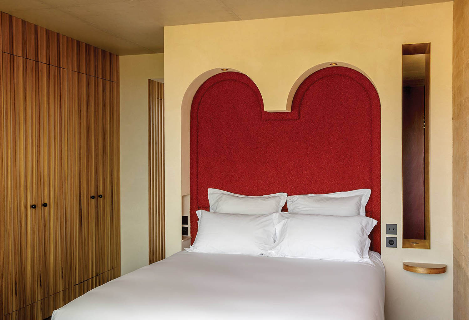 A bed with a heart shaped headboard.