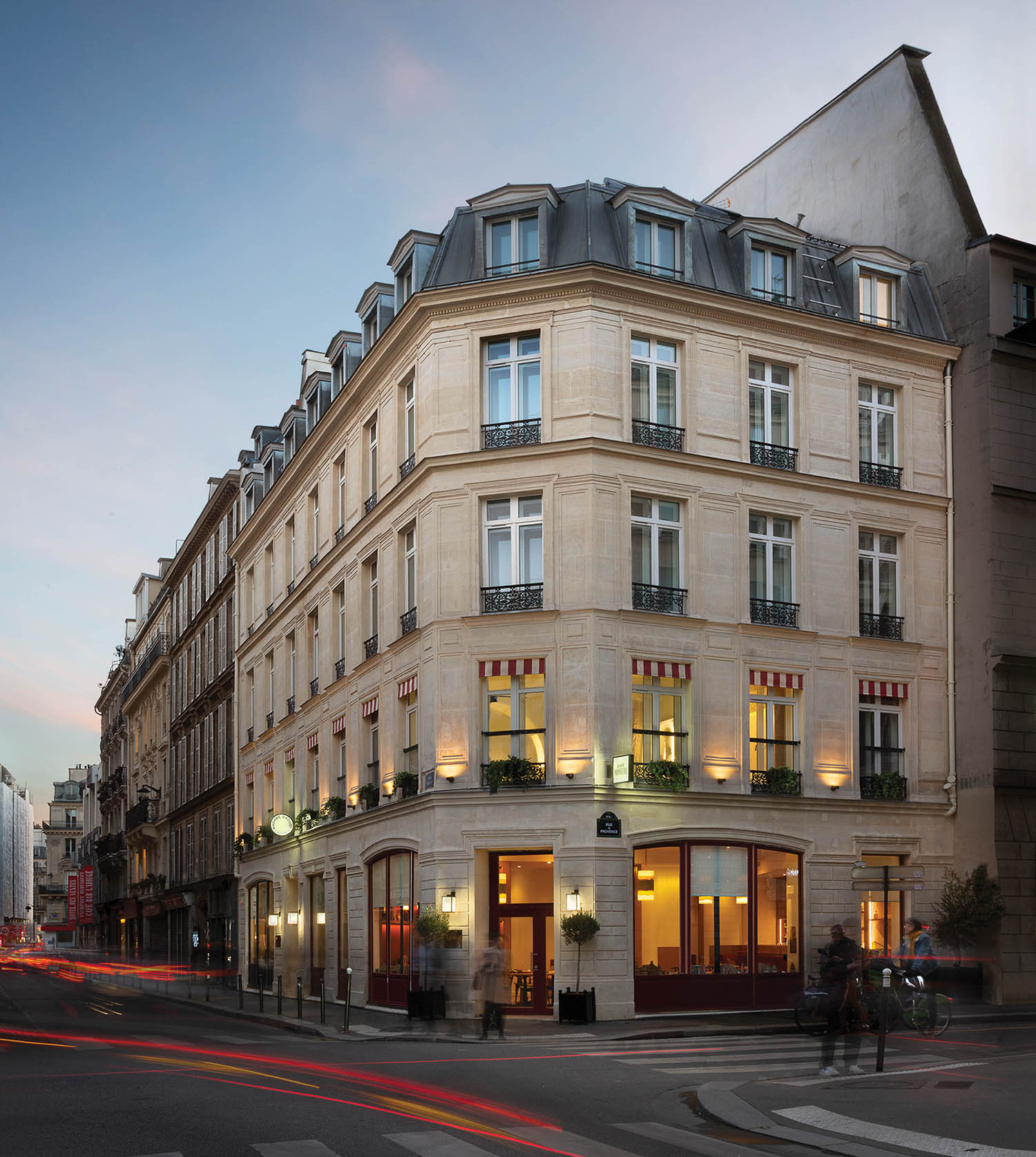 A street with a building and a car.