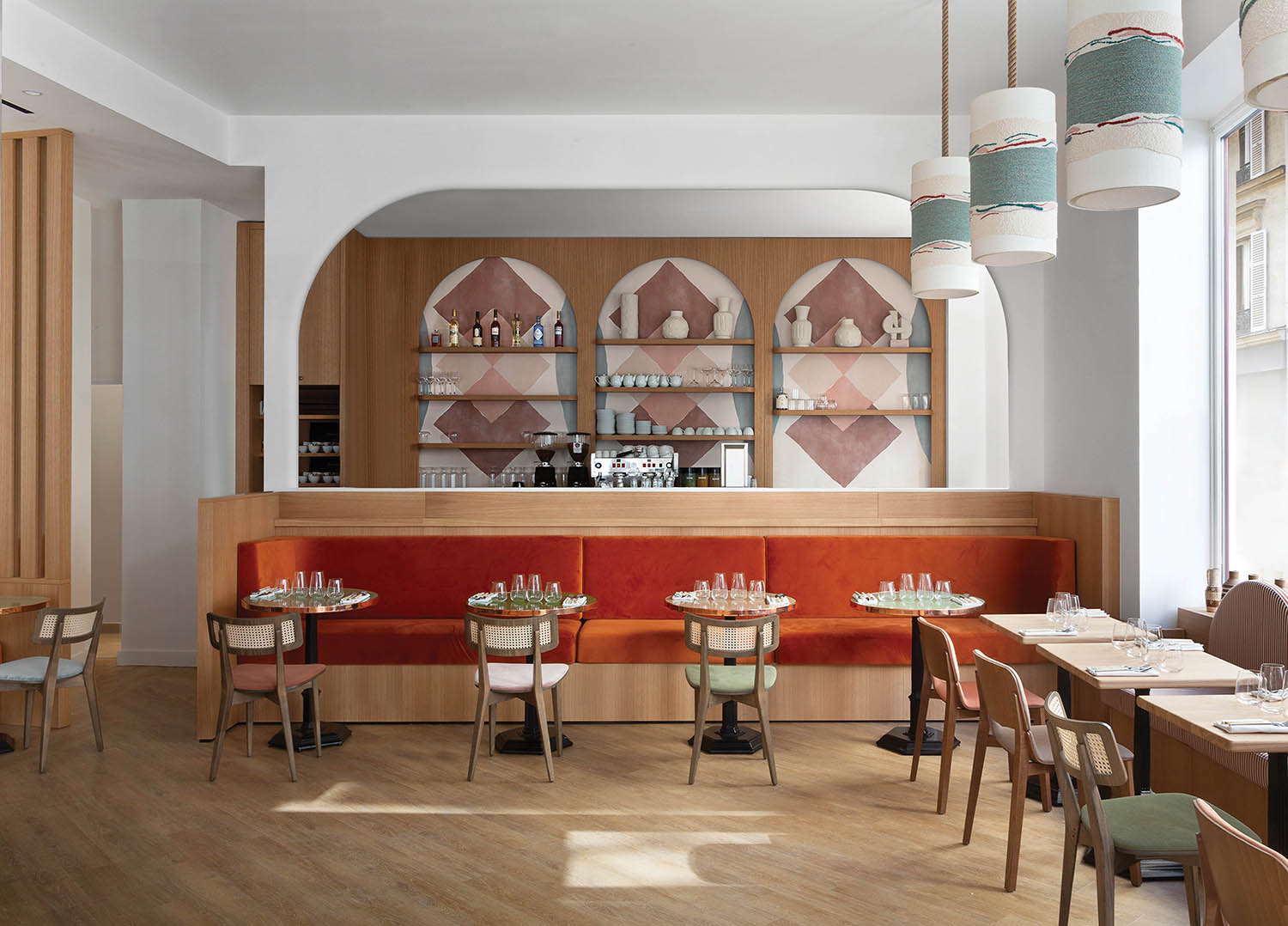 A restaurant with wooden tables and chairs.