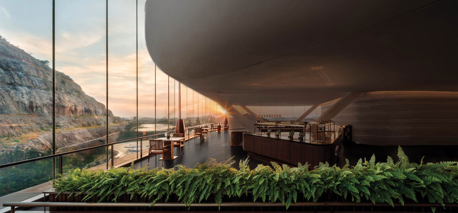 The restaurant at the Banyan Tree Nanjing Garden Expo, a luxury hotel with interiors by Cheng Chung Design, overlooks and is inspired by the abandoned Tangshan Mountain quarry visible through the 33-foot-high glass curtain wall.