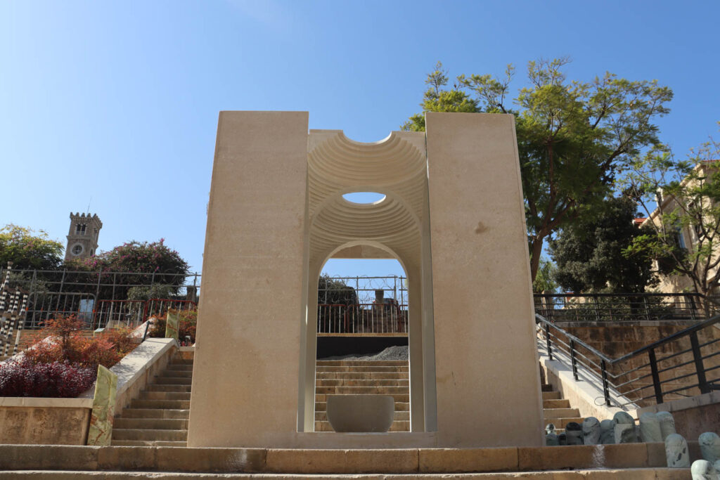 a white sculptural archway outdoors