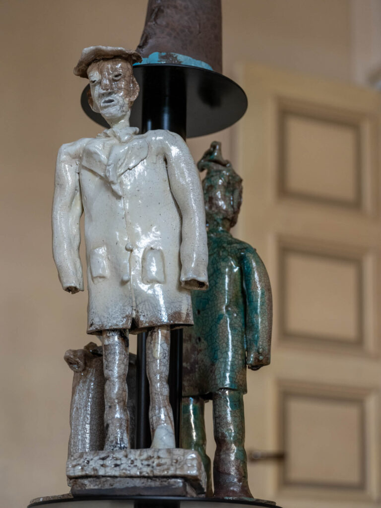 a sculptural lamp with a person carved into the base