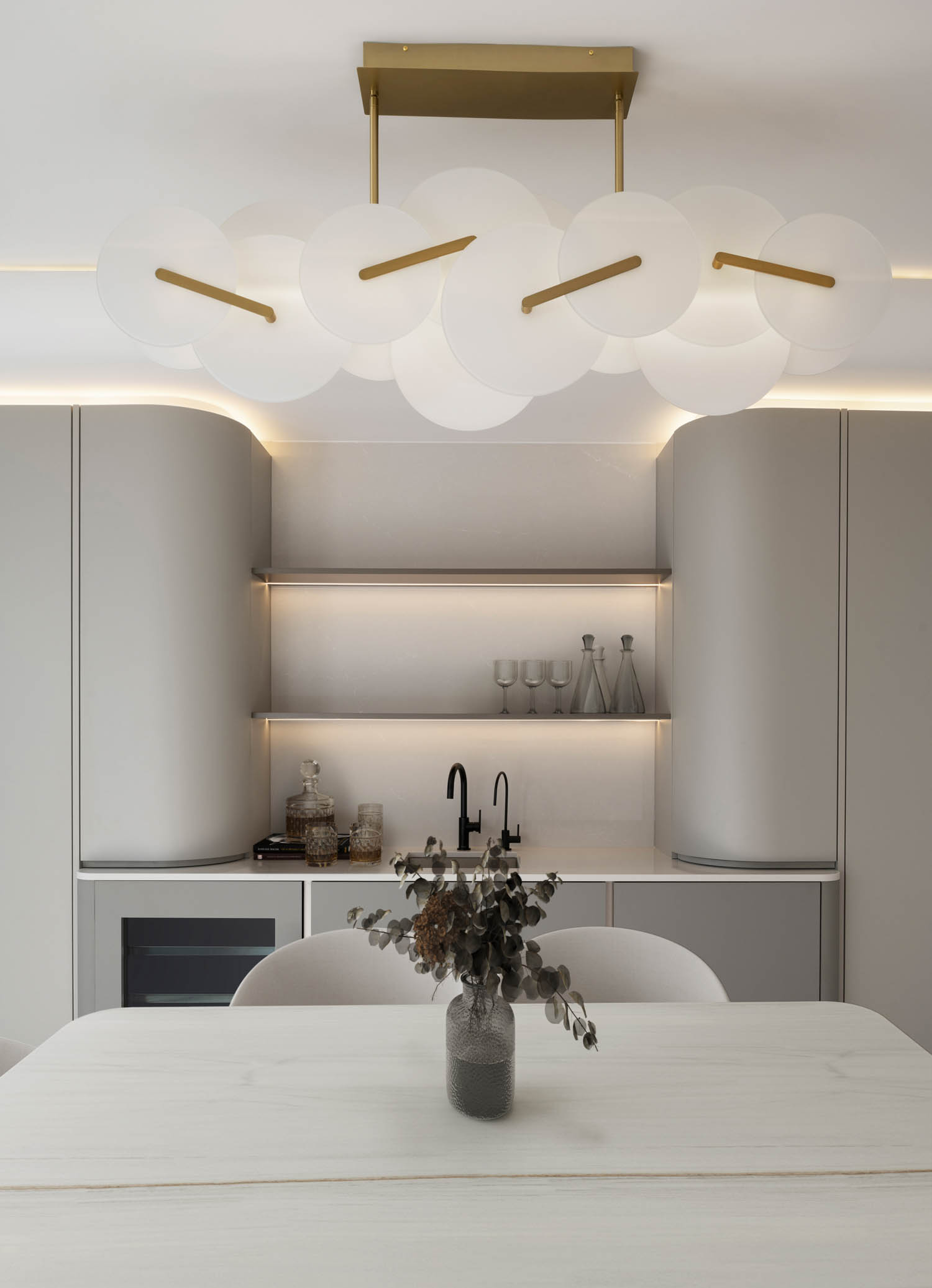 dining area with flower vase and bar