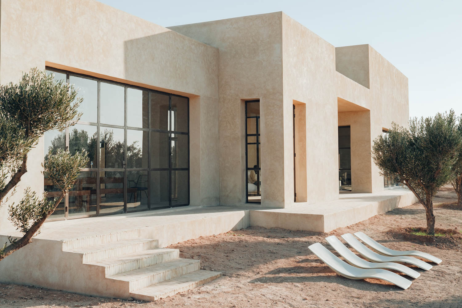 exterior of home with long chairs and stairs