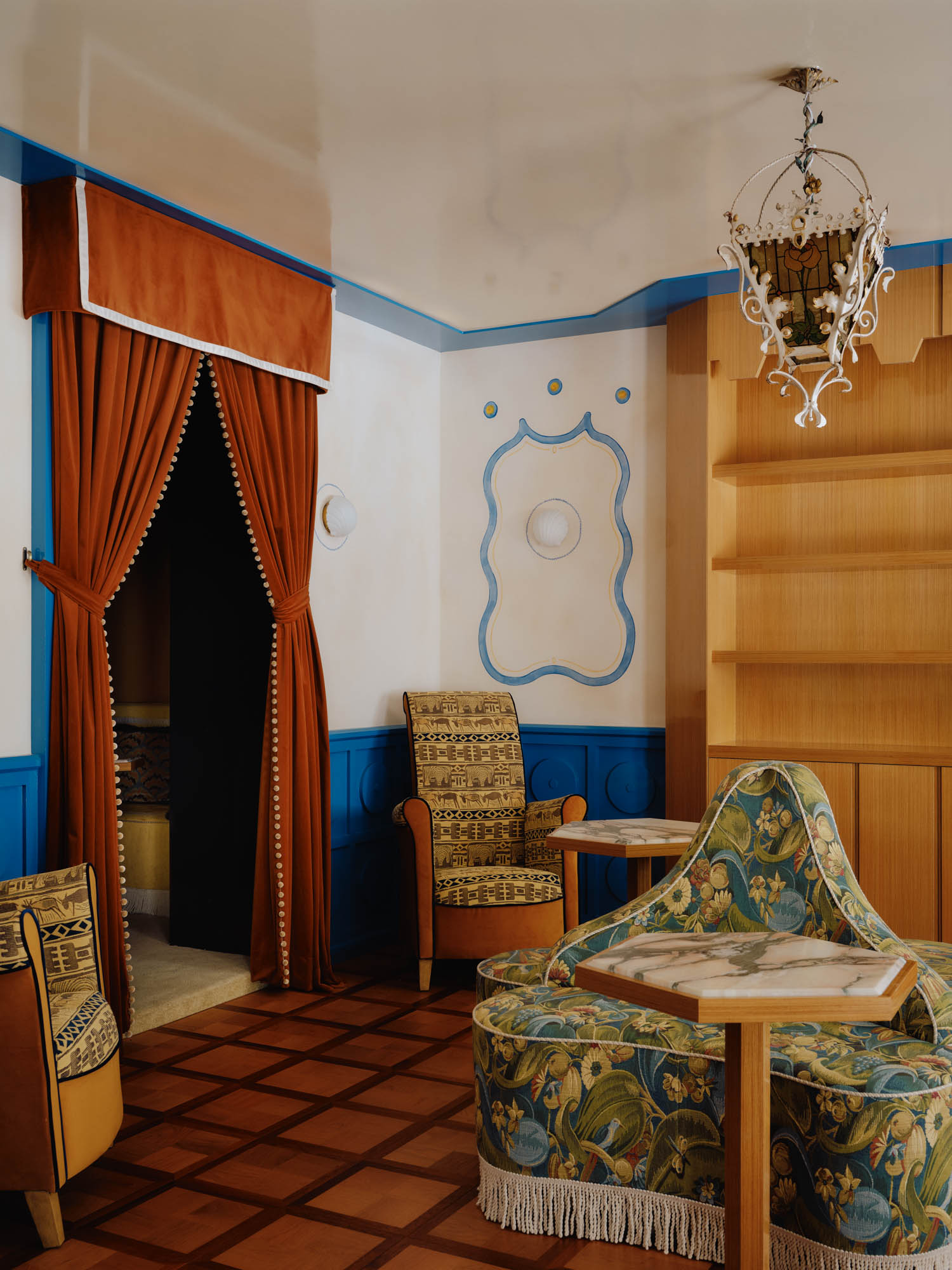 gift zone with patterned chairs and dramatic curtains