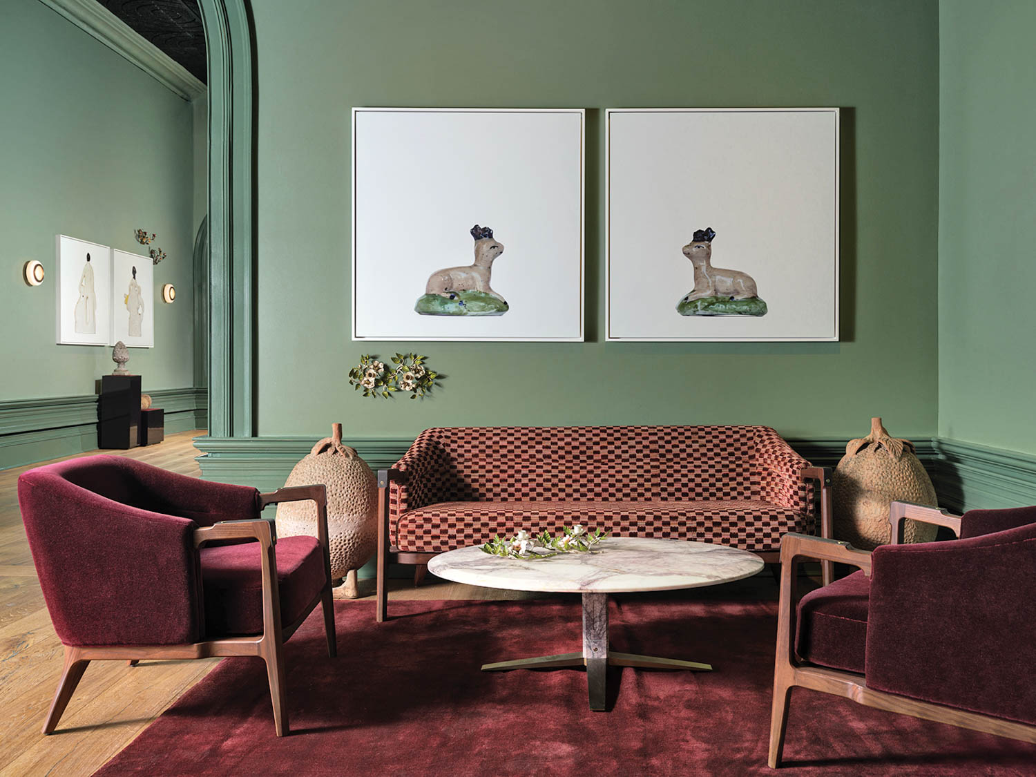 living room area with mahogany chairs and artwork